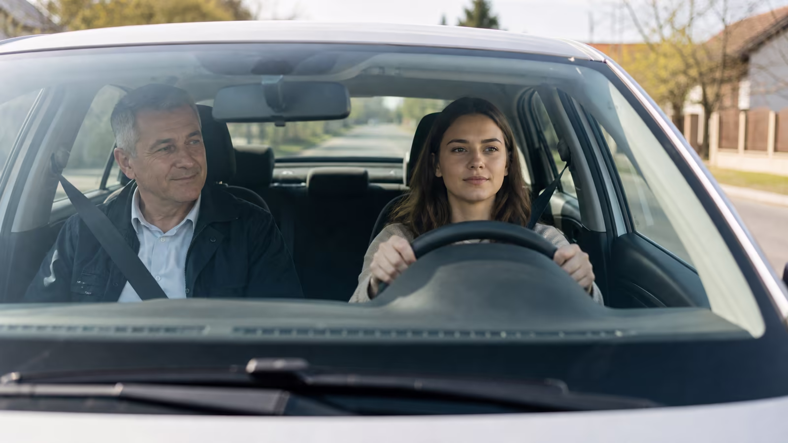 Mladá žena pri prvej jazde v autoškole zhlboka dýcha a drží volant – strach nie je od Boha